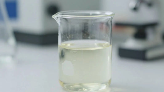 Laboratory beaker with pale liquid, scientific research.